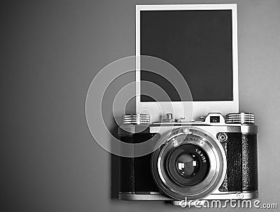 Blank instant photo frame on gray background highlighted with old retro vintage camera and copy space Stock Photo
