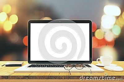 Blank laptop screen on wooden table with eyeglasses and cup of c Stock Photo