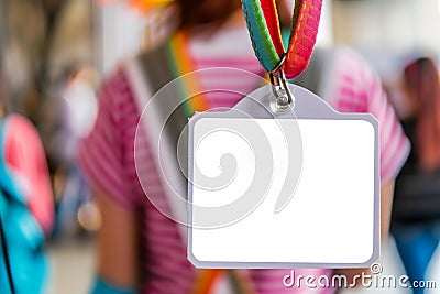 blank nametag on a colorful lanyard, person in the background Stock Photo