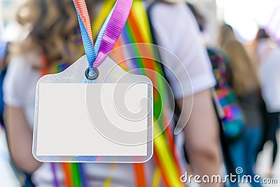 blank nametag on a colorful lanyard, person in the background Stock Photo