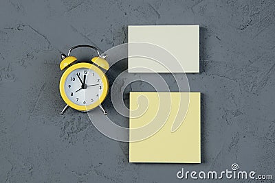 Blank note with clock on gray background Stock Photo