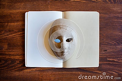 Blank notebook with papier-mÃ¢chÃ© mask Stock Photo