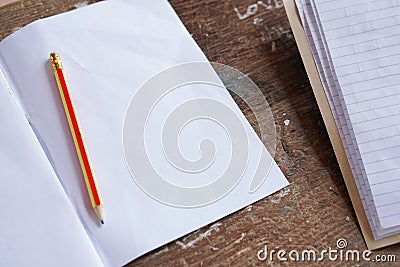 Blank notebook and pencil Open on the old wood desk. Schools that are far from the prosperity of technology, education Stock Photo