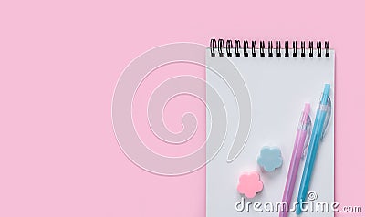 Blank notepad, colored pen and erasers on a pink background. Flatlay. Top view. Copy space Stock Photo