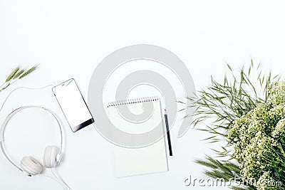 Blank notepad near bouquet of white wild flowers Stock Photo