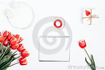 Blank notepad near red flowers, gift box and headphones Stock Photo