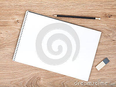 Blank notepad, pencil and eraser on the wooden table Stock Photo