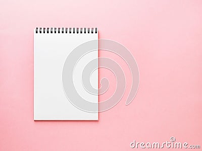 Blank notepad white page on pink desk, color background. Top vie Stock Photo