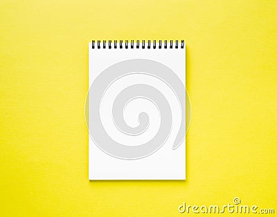 Blank notepad white page on yellow desk, color background. Top v Stock Photo