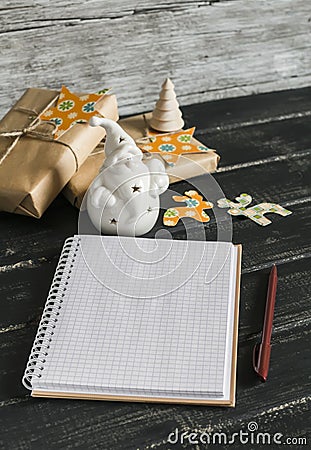Blank open Notepad, ceramic Santa Claus, Christmas gifts Stock Photo
