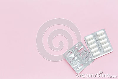 Blank packaging from tablets and blister of pills on pink background. Concept of course medication. Stock Photo