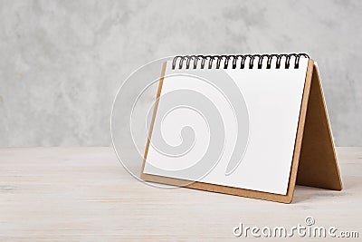 Blank paper calendar on wooden table Stock Photo
