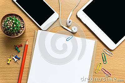 Blank paper, color pencil, and smart phone on wood desk Stock Photo