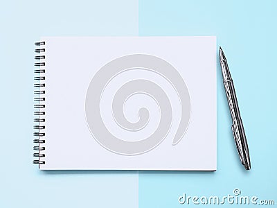 Notepad amd a pen on cyan background Stock Photo