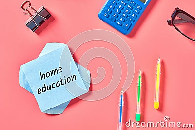 Blank paper sticker with words home education near stationery items Stock Photo