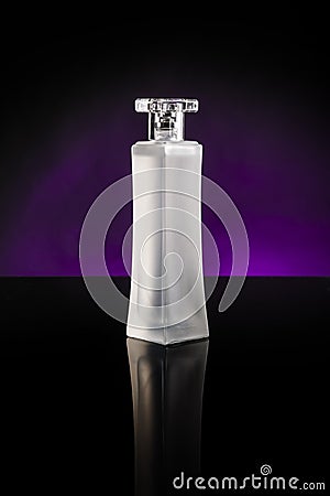 Blank perfume bottle reflected on black over violet color background Stock Photo