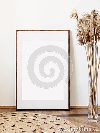 Blank picture frame mockup on white wall. Artwork in minimal interior design. View of modern boho style interior with canvas Stock Photo