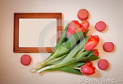 Blank picture frame, tulips and macaroons Stock Photo