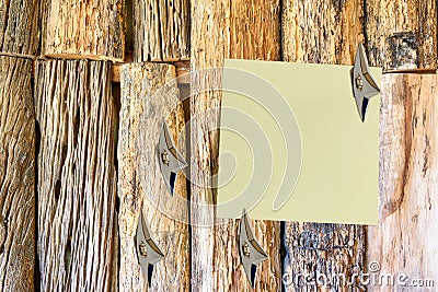 Blank piece of paper attached on an old wooden wall with Japanese ninja concealed weapons. Stock Photo