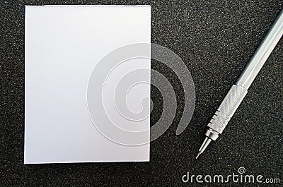 Blank post it paper book with pencil, on black sandpaper texture Stock Photo