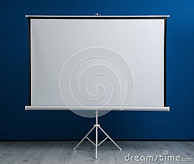 Blank projection screen near blue wall indoors Stock Photo