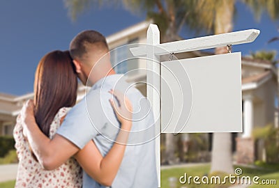 Blank Real Estate Sign and Military Couple Looking at House Stock Photo