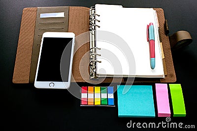 Blank ring binder planner with index tabs, mobile phone and note pads use for time management in personal or business Stock Photo