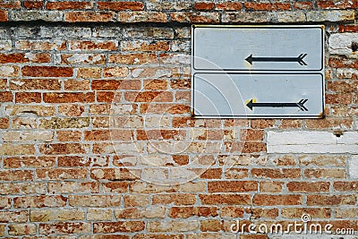 Blank road signposts against a brick wall Stock Photo