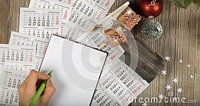 Blank sheet of paper and small paper house with coins on the New Year& x27;s background Stock Photo