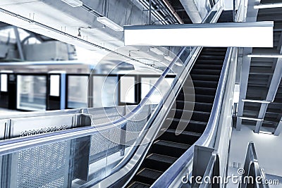 Blank sign board in subway train station with escalator background. It is direction signage mock up for information public Stock Photo