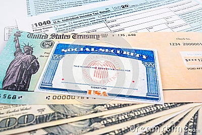 Blank social security card, united states treasury stimulus check and 1040 us individual tax income return form and dollar Editorial Stock Photo