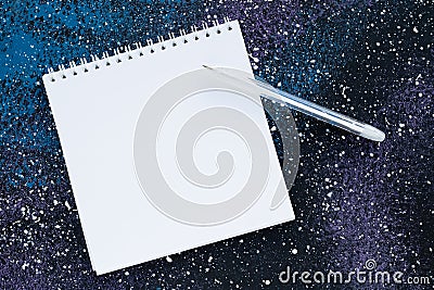 Blank spiral notebook with copy space for text on abstract dark blue background. Planning concept. White paper page and pen, empty Stock Photo