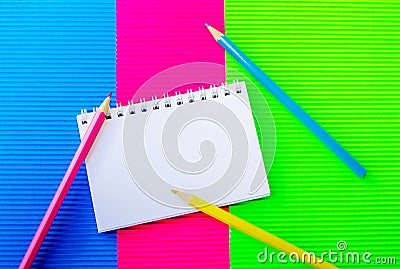 Blank spiral notepad and colorful pencils Stock Photo