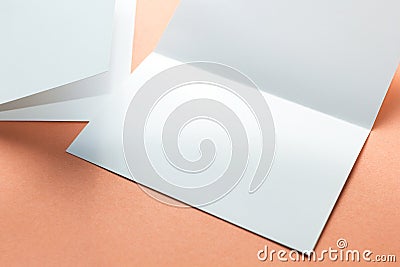 Blank square two-leaf brochures isolated on orange background. Space for text Stock Photo