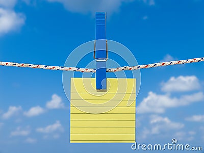 Blank square of yellow paper suspended from a washing line. Stock Photo