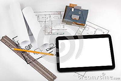 Blank tablet and house scale model on architectural blueprints Stock Photo