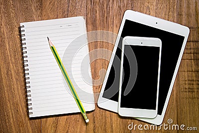 blank tablet and phone with an empty folder on a wooden workspace Stock Photo