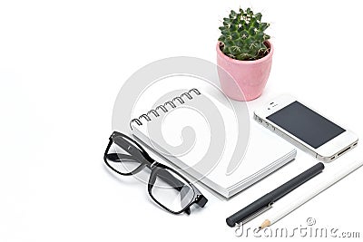 Blank template spiral white notebook notepad, cactus in pot, eye glasses, pencil, smartphone isolated white background Stock Photo