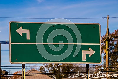 Blank traffic sign with arrows pointing in opposite directions Stock Photo