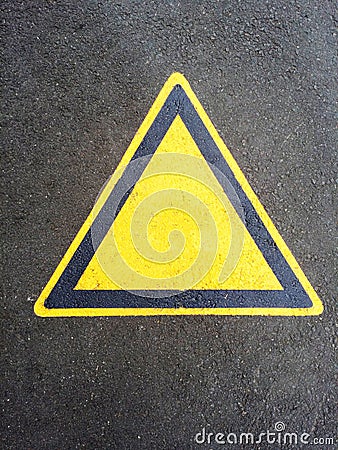 Blank triangle hazard, attention, warning, danger sign on the black asphalt Stock Photo