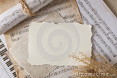 Blank vintage paper card on aged music notes background. Empty grunge postcard with copy space Stock Photo