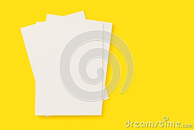 Blank white cover magazines stack mockup on yellow background Stock Photo