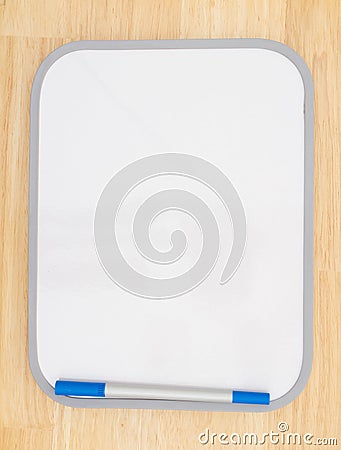 Blank white dry erase board with marker on wood textured background Stock Photo