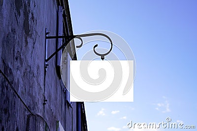 Blank white empty vintage mockup signboard on facade shop wall Stock Photo