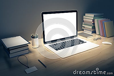 Blank white laptop screen with books and pen on wooden table, mo Editorial Stock Photo