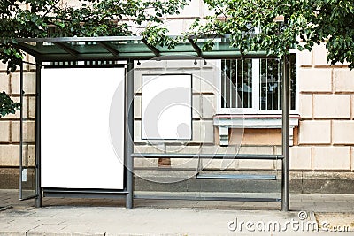 Blank white mock up of bus stop vertical billboard in front of empty street background Stock Photo