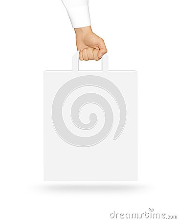 Blank white paper bag mock up holding in hand. Empty plastic pac Stock Photo