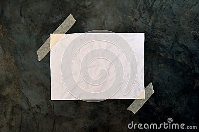 Blank white paper on rough black surface Stock Photo