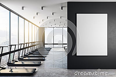 Blank white poster on black wall in modern gym at sunrise Stock Photo