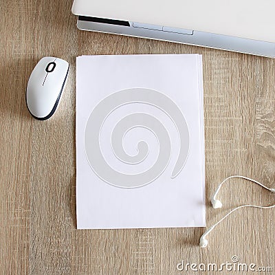 A4 blank white pperon table with laptop and mouse Stock Photo